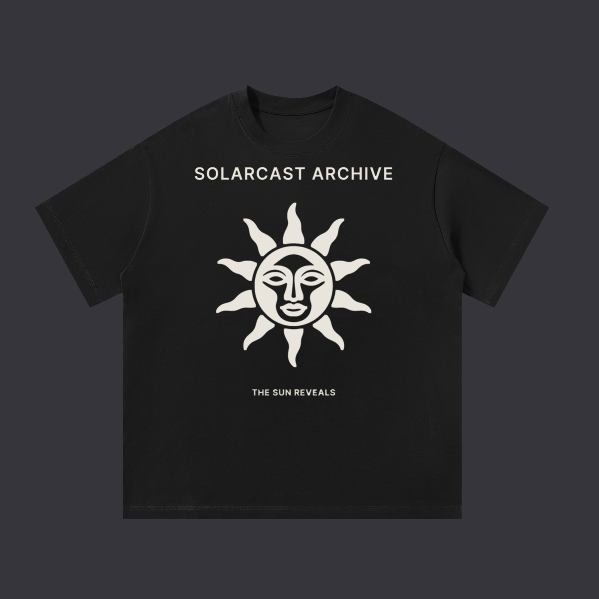The Sun Reveals tee: a bone print on the front showing a sun with a face and rays above the words The Sun Reveals, on a black cotton tee.